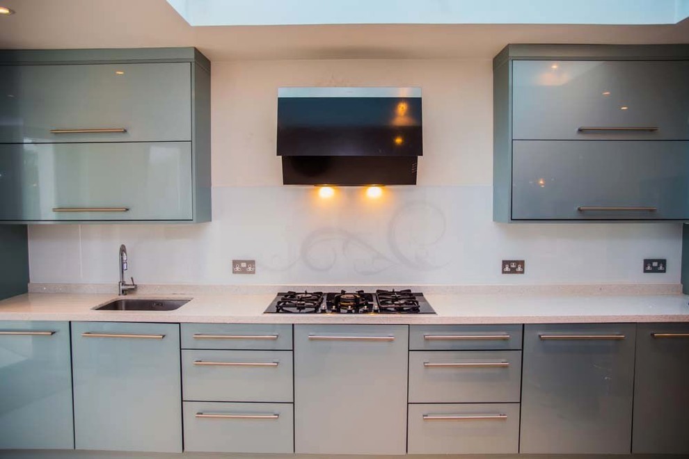 Minimalist kitchen photo in Hertfordshire with white backsplash and glass sheet backsplash