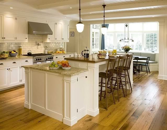 Large transitional l-shaped medium tone wood floor eat-in kitchen photo with an integrated sink, shaker cabinets, white cabinets, granite countertops, white backsplash, subway tile backsplash, stainless steel appliances and an island