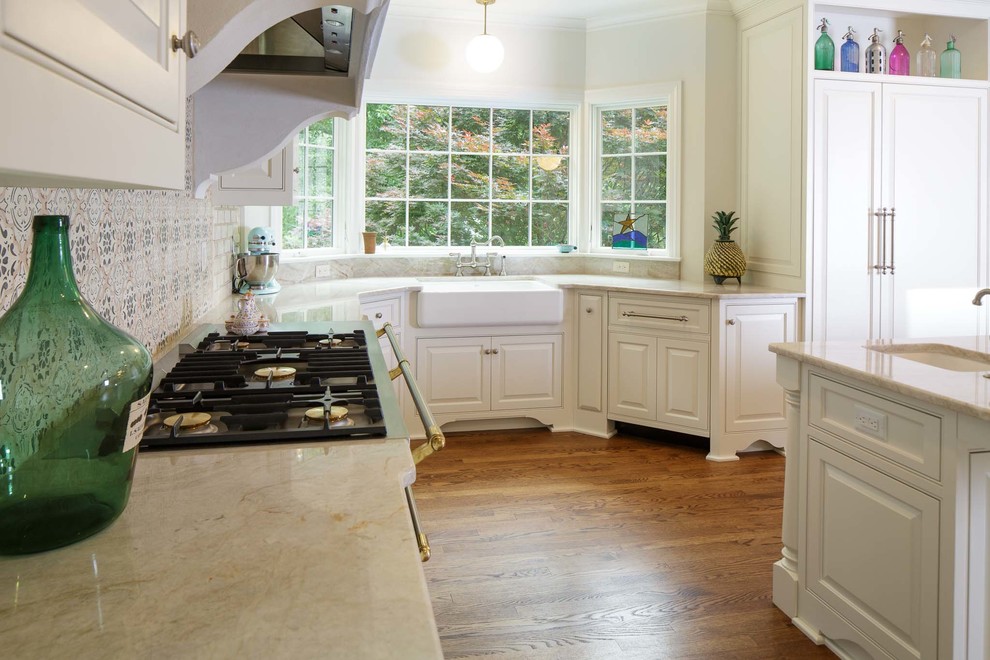 Inspiration for a large timeless l-shaped medium tone wood floor kitchen remodel in Nashville with a farmhouse sink, beaded inset cabinets, white cabinets, marble countertops, multicolored backsplash, mosaic tile backsplash, paneled appliances and an island