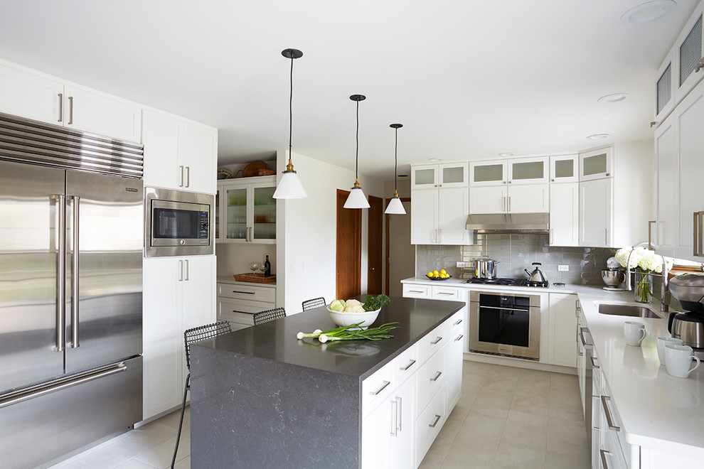 Eat-in kitchen - large contemporary galley porcelain tile eat-in kitchen idea in Chicago with an undermount sink, recessed-panel cabinets, white cabinets, quartz countertops, gray backsplash, glass tile backsplash, stainless steel appliances and an island