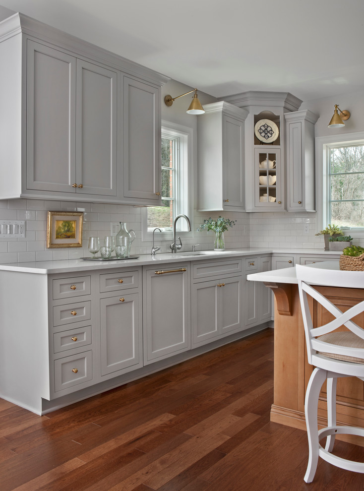 Example of a large transitional u-shaped medium tone wood floor eat-in kitchen design in Detroit with beaded inset cabinets, gray cabinets, quartz countertops, white backsplash and an island