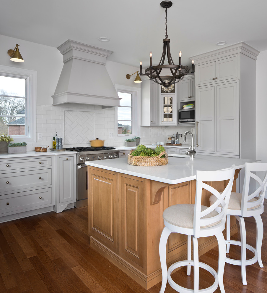 Inspiration for a large transitional u-shaped medium tone wood floor eat-in kitchen remodel in Detroit with flat-panel cabinets, gray cabinets, quartz countertops, white backsplash and an island