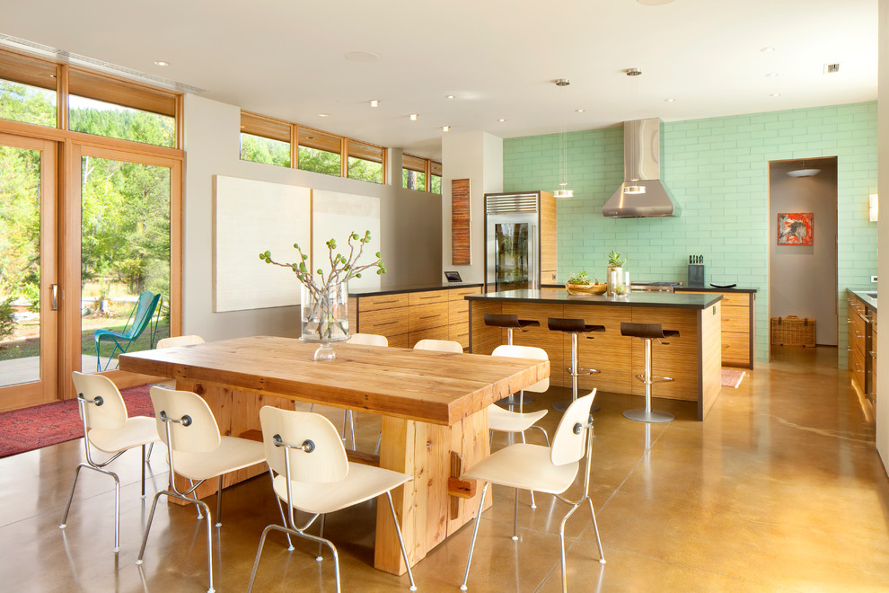 This is an example of a contemporary u-shaped kitchen in Other with flat-panel cabinets, medium wood cabinets, green splashback and glass tiled splashback.