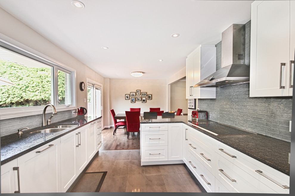 Eat-in kitchen - mid-sized contemporary u-shaped ceramic tile and beige floor eat-in kitchen idea in Ottawa with a double-bowl sink, shaker cabinets, white cabinets, granite countertops, gray backsplash, ceramic backsplash, stainless steel appliances and a peninsula