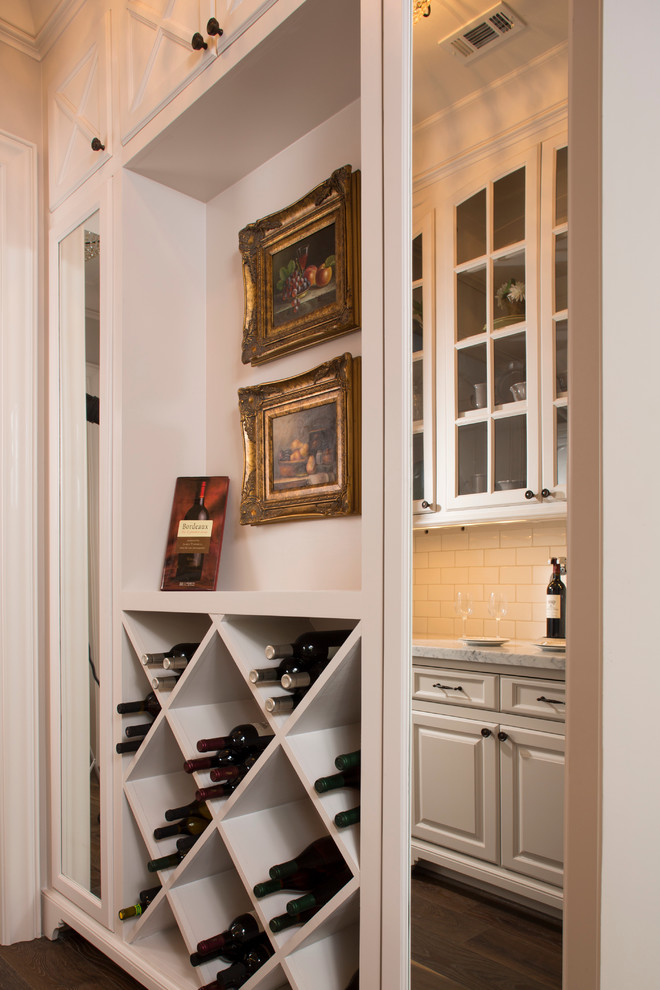 Inspiration for a mid-sized timeless medium tone wood floor and brown floor wine cellar remodel in Houston with storage racks