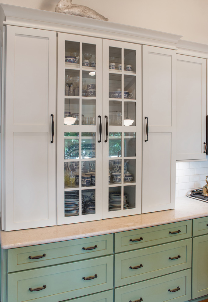 Photo of a large country galley kitchen pantry in Milwaukee with green cabinets, engineered stone countertops, white splashback, metro tiled splashback and an island.