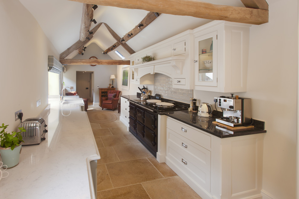 Photo of a medium sized rural galley kitchen in London with a belfast sink, shaker cabinets and beige floors.