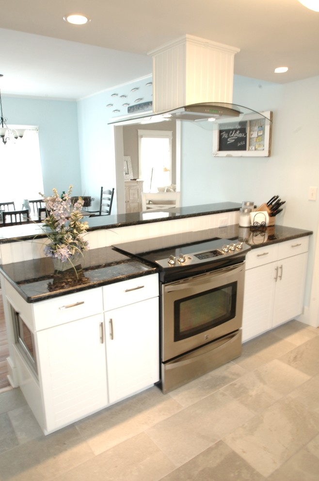 Classic galley kitchen/diner in Boston with shaker cabinets, white cabinets, granite worktops, white splashback and stainless steel appliances.