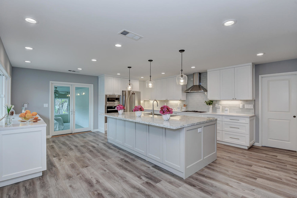 Example of a large trendy ceramic tile and gray floor open concept kitchen design in San Francisco with a single-bowl sink, raised-panel cabinets, white cabinets, quartzite countertops, gray backsplash, porcelain backsplash, stainless steel appliances, an island and gray countertops