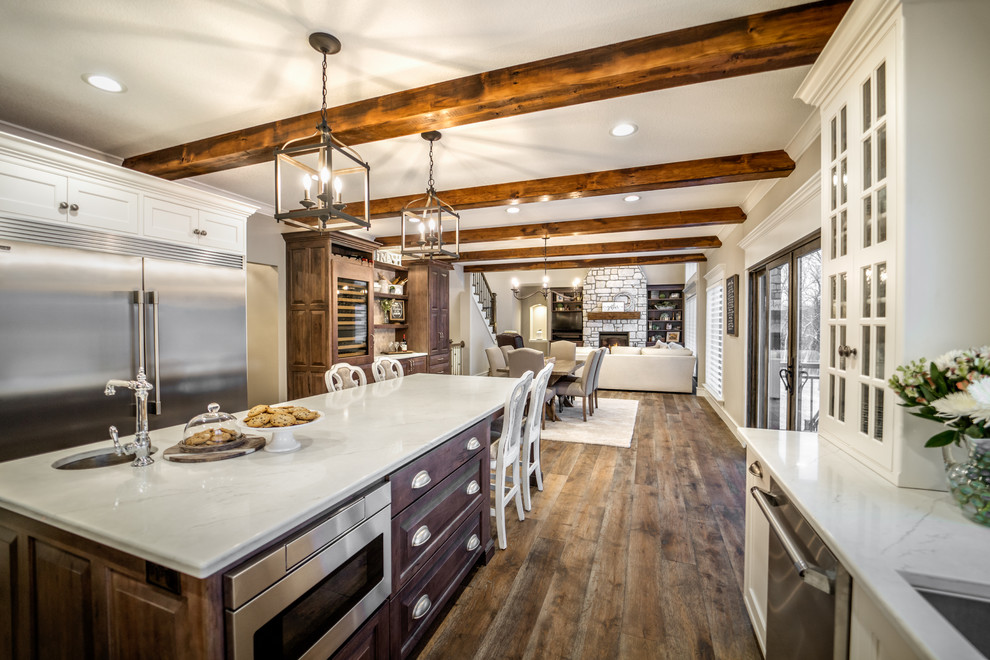 This is an example of a large rustic open plan kitchen in Other with stainless steel appliances and an island.
