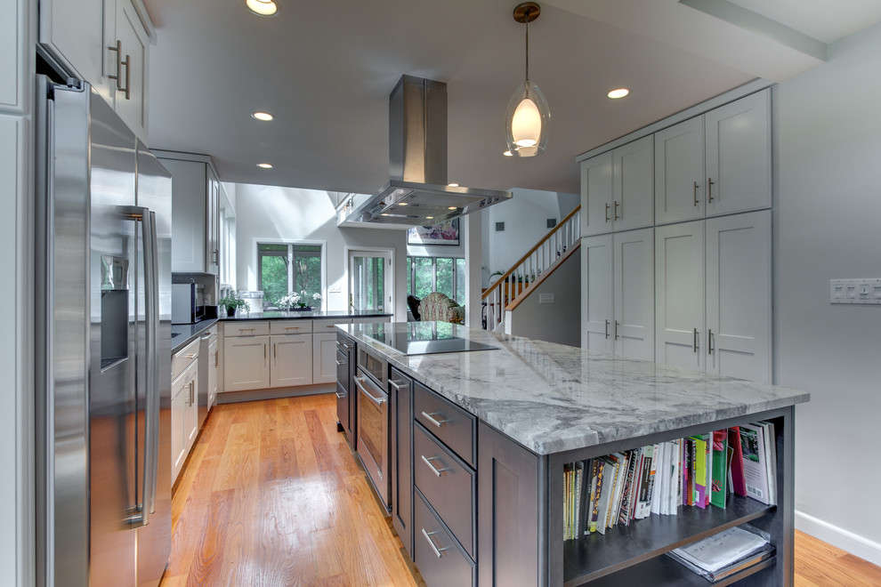 Eat-in kitchen - large transitional l-shaped medium tone wood floor eat-in kitchen idea in Boston with shaker cabinets, gray cabinets, granite countertops, an island, an undermount sink and stainless steel appliances