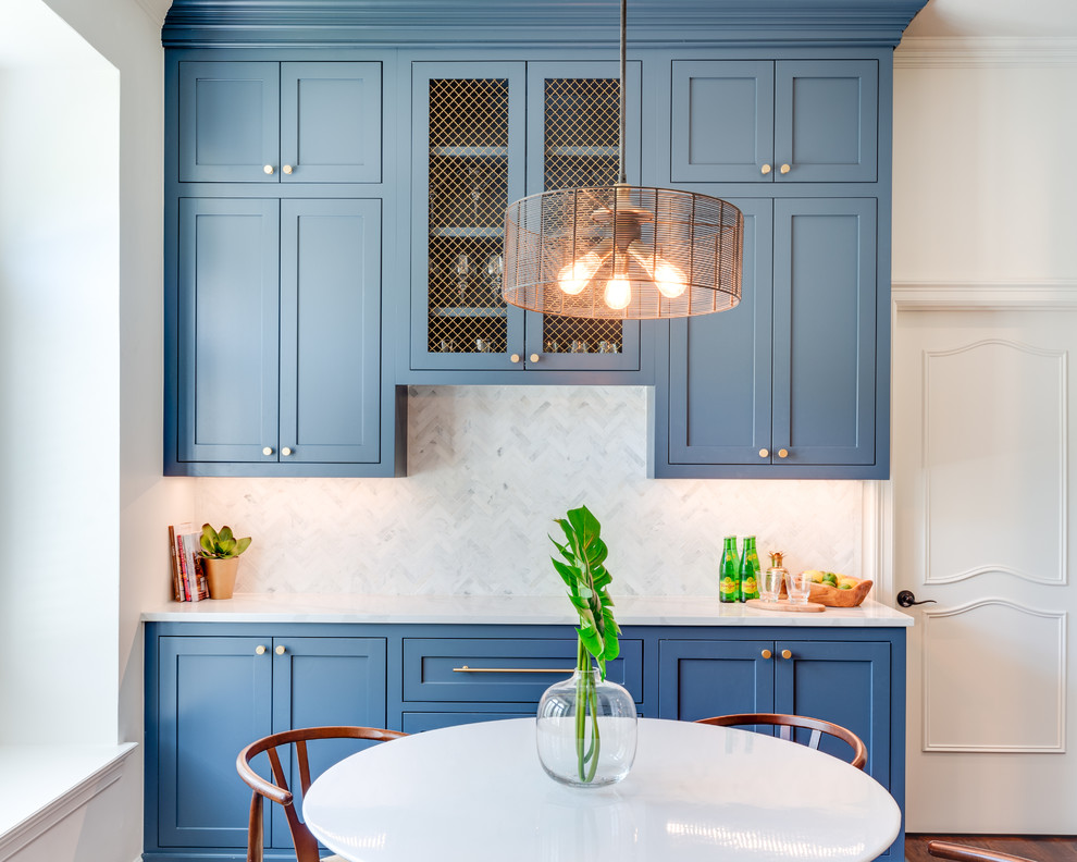 Inspiration for a large transitional l-shaped medium tone wood floor and brown floor open concept kitchen remodel in Dallas with an undermount sink, shaker cabinets, blue cabinets, marble countertops, gray backsplash, marble backsplash, stainless steel appliances, an island and white countertops