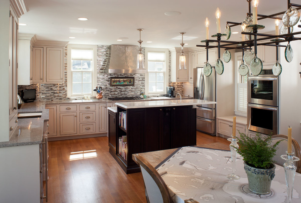 Eat-in kitchen - large coastal u-shaped medium tone wood floor and brown floor eat-in kitchen idea in Providence with a double-bowl sink, beaded inset cabinets, white cabinets, quartz countertops, multicolored backsplash, matchstick tile backsplash, stainless steel appliances and an island