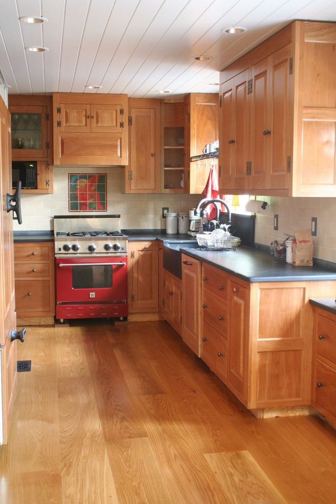 Foto på ett litet vintage u-kök, med en integrerad diskho, skåp i ljust trä, bänkskiva i täljsten, ljust trägolv och beiget golv