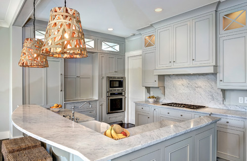 Traditional kitchen with light gray RTA cabinets, marble countertops, and woven pendant lighting