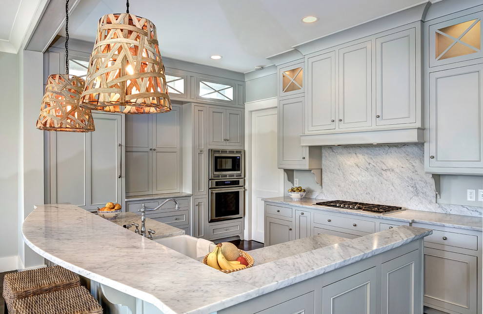 Example of a mid-sized classic l-shaped dark wood floor and brown floor kitchen design in Charleston with a farmhouse sink, gray cabinets, white backsplash, paneled appliances, beaded inset cabinets, stone slab backsplash, an island and quartzite countertops