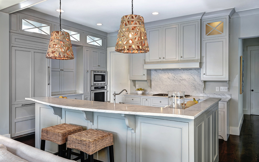 Example of a mid-sized classic l-shaped dark wood floor and brown floor kitchen design in Charleston with a farmhouse sink, beaded inset cabinets, gray cabinets, quartzite countertops, white backsplash, stone slab backsplash, paneled appliances and an island