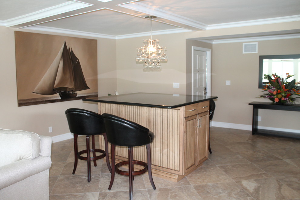 Example of a mid-sized island style u-shaped travertine floor eat-in kitchen design in Miami with an undermount sink, recessed-panel cabinets, granite countertops, stainless steel appliances and an island