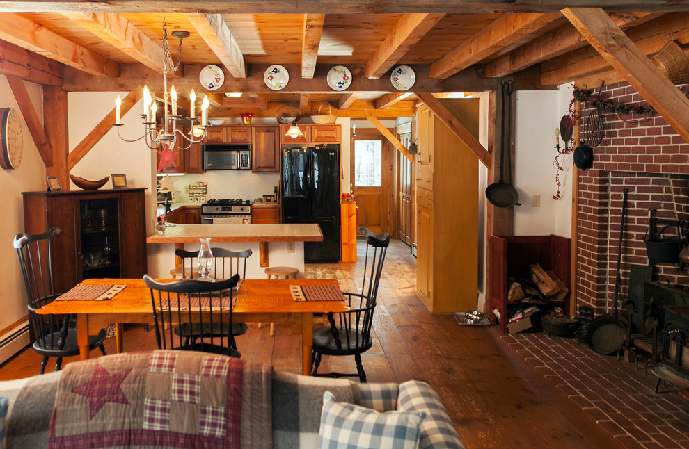 Medium sized farmhouse u-shaped kitchen pantry in Boston with medium wood cabinets, tile countertops, medium hardwood flooring and a breakfast bar.