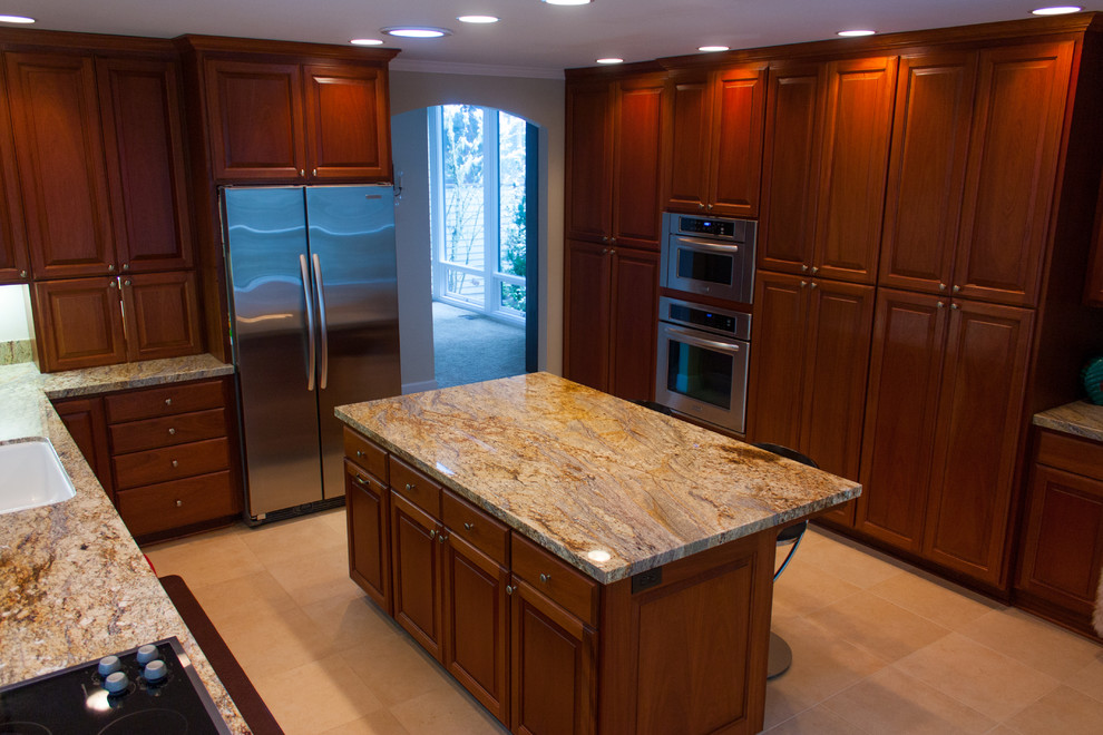 Enclosed kitchen - large contemporary l-shaped travertine floor enclosed kitchen idea in Other with an undermount sink, raised-panel cabinets, dark wood cabinets, stainless steel appliances and an island