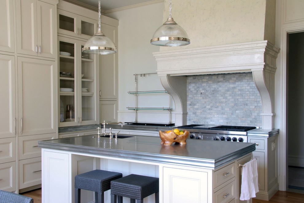 Transitional kitchen photo in Los Angeles with glass-front cabinets, beige cabinets, zinc countertops, multicolored backsplash, stone tile backsplash and paneled appliances