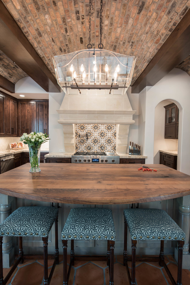 Large tuscan u-shaped eat-in kitchen photo in Dallas with brown cabinets, multicolored backsplash and an island