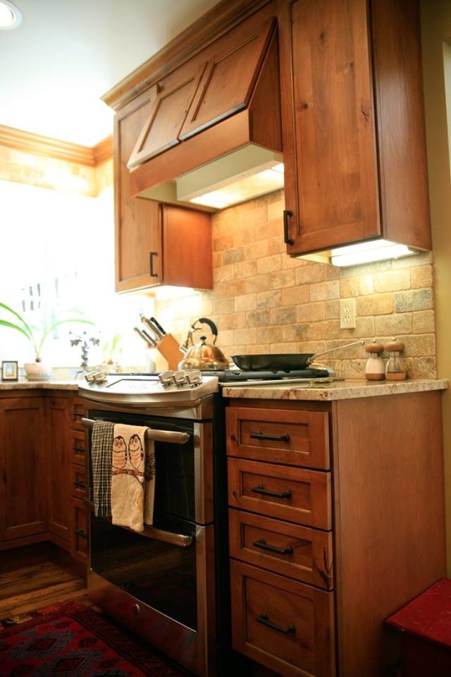 Inspiration for a medium sized classic l-shaped kitchen in San Diego with a submerged sink, shaker cabinets, medium wood cabinets, granite worktops, beige splashback, brick splashback, medium hardwood flooring and an island.