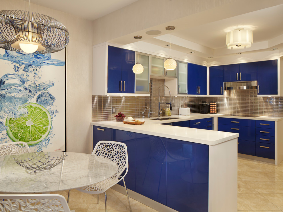 Mid-sized trendy u-shaped marble floor eat-in kitchen photo in Miami with flat-panel cabinets, blue cabinets, metallic backsplash, metal backsplash, a drop-in sink, quartzite countertops, stainless steel appliances and a peninsula