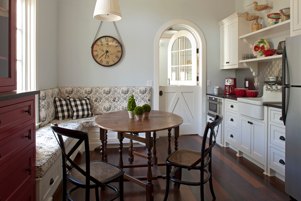 Eat-in kitchen - coastal eat-in kitchen idea in Miami with a farmhouse sink, shaker cabinets, white cabinets, metallic backsplash and stainless steel appliances