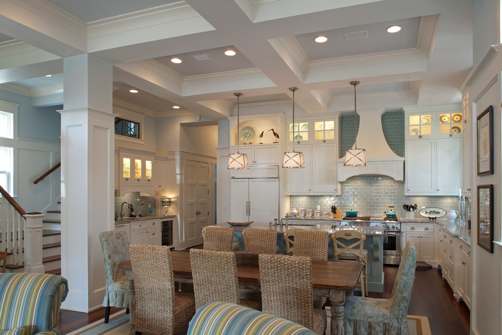 Inspiration for a coastal u-shaped open concept kitchen remodel in Miami with recessed-panel cabinets, white cabinets, blue backsplash, subway tile backsplash and paneled appliances