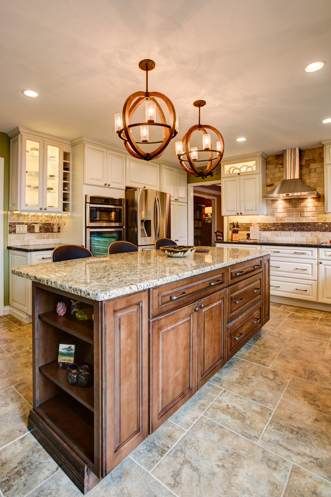 Mid-sized elegant galley ceramic tile eat-in kitchen photo in Other with an undermount sink, raised-panel cabinets, white cabinets, granite countertops, brown backsplash, ceramic backsplash, stainless steel appliances and an island