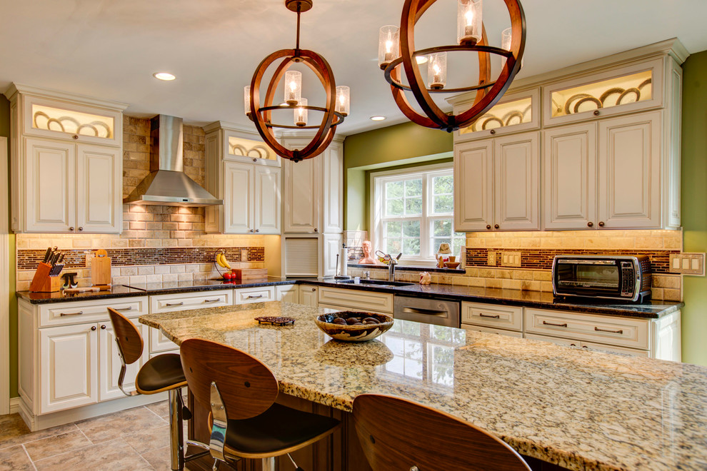 Eat-in kitchen - mid-sized traditional galley ceramic tile eat-in kitchen idea in Other with an undermount sink, raised-panel cabinets, white cabinets, granite countertops, brown backsplash, ceramic backsplash, stainless steel appliances and an island