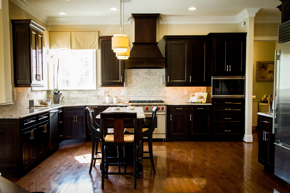 Inspiration for a large timeless u-shaped dark wood floor enclosed kitchen remodel in Philadelphia with an undermount sink, shaker cabinets, dark wood cabinets, granite countertops, white backsplash, subway tile backsplash, stainless steel appliances and an island
