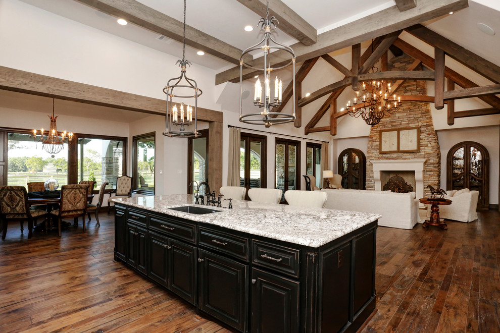 Inspiration for a large transitional l-shaped medium tone wood floor eat-in kitchen remodel in Houston with an undermount sink, dark wood cabinets, granite countertops, beige backsplash, porcelain backsplash, paneled appliances, an island and raised-panel cabinets