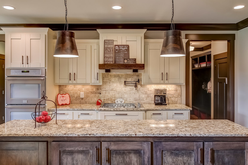 Inspiration for a rustic galley eat-in kitchen remodel in Nashville with a single-bowl sink, shaker cabinets, white cabinets, granite countertops, beige backsplash, stainless steel appliances and an island