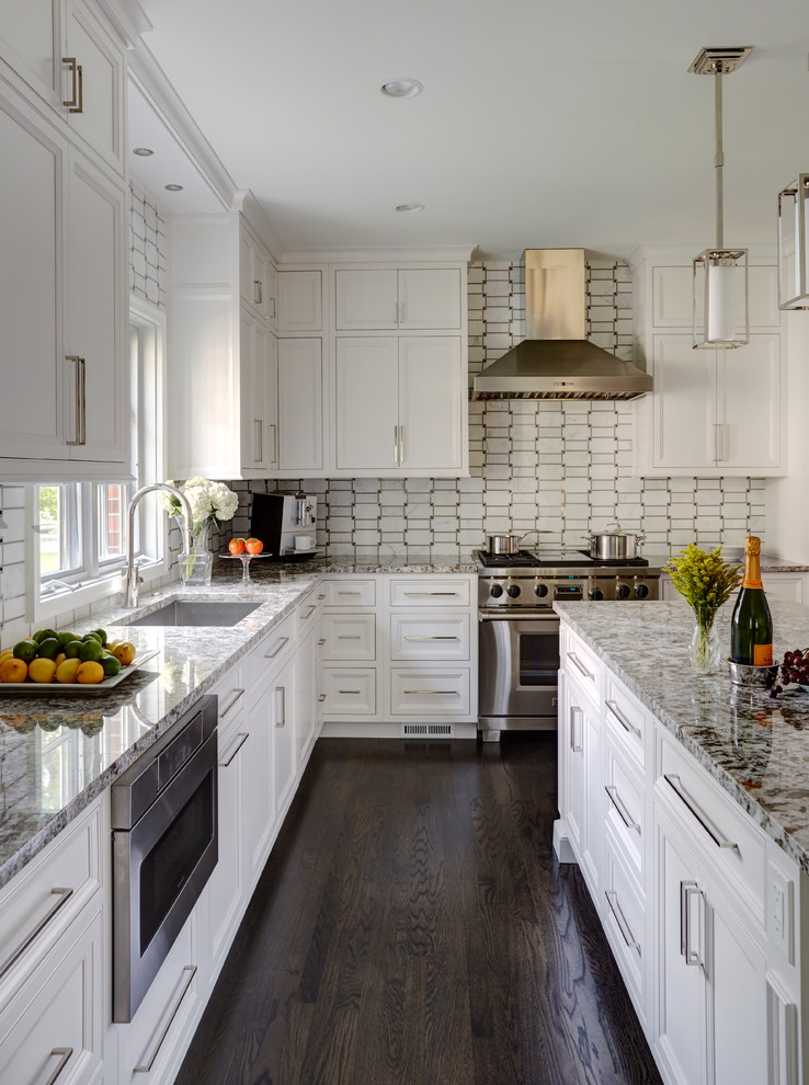 Design ideas for a traditional l-shaped kitchen in Chicago with a submerged sink, beaded cabinets, white cabinets, white splashback, stainless steel appliances, dark hardwood flooring and an island.