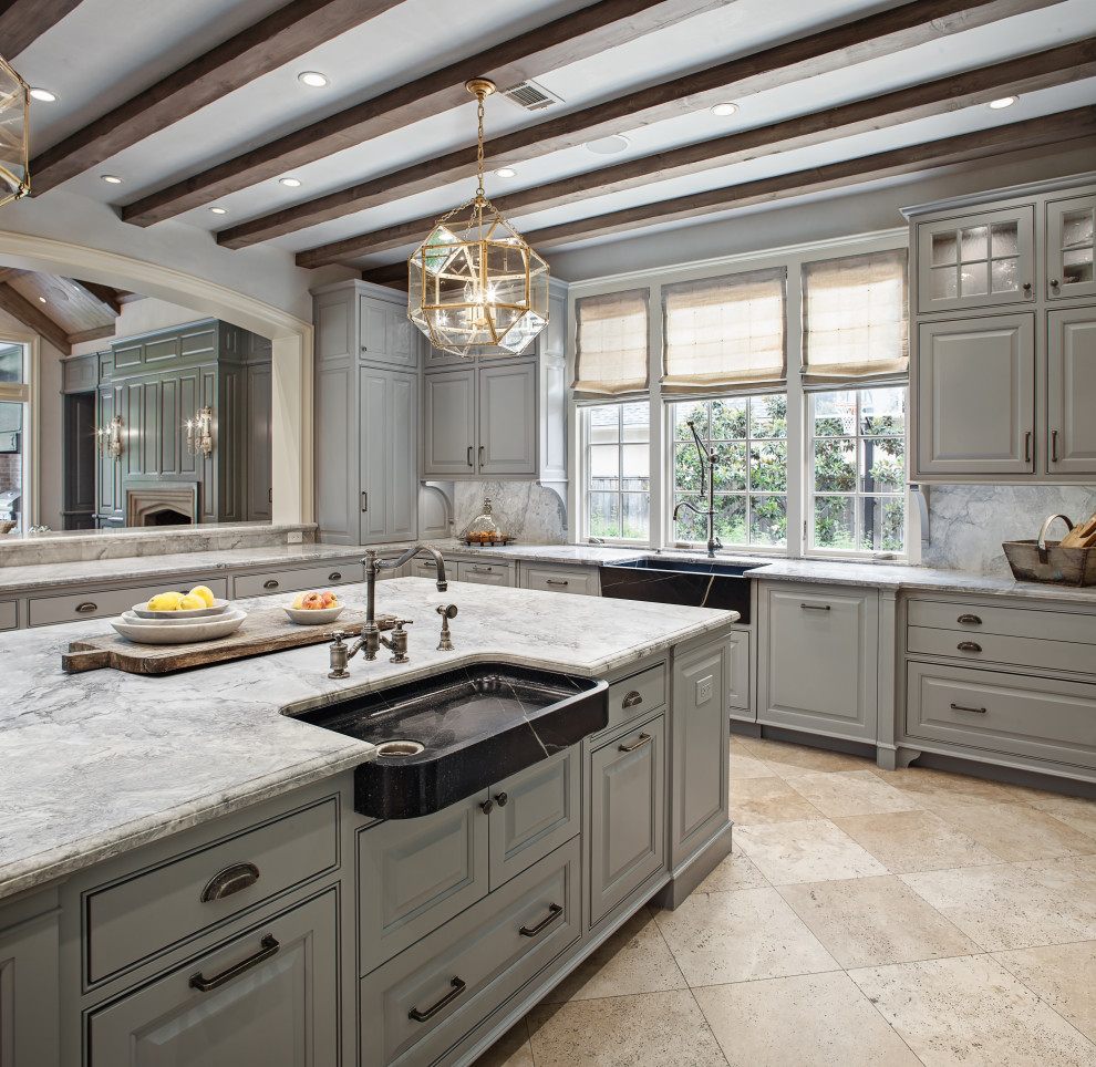 Mid-sized transitional u-shaped travertine floor and beige floor enclosed kitchen photo in Houston with a farmhouse sink, beaded inset cabinets, gray cabinets, quartzite countertops, gray backsplash, stone slab backsplash, paneled appliances, an island and gray countertops