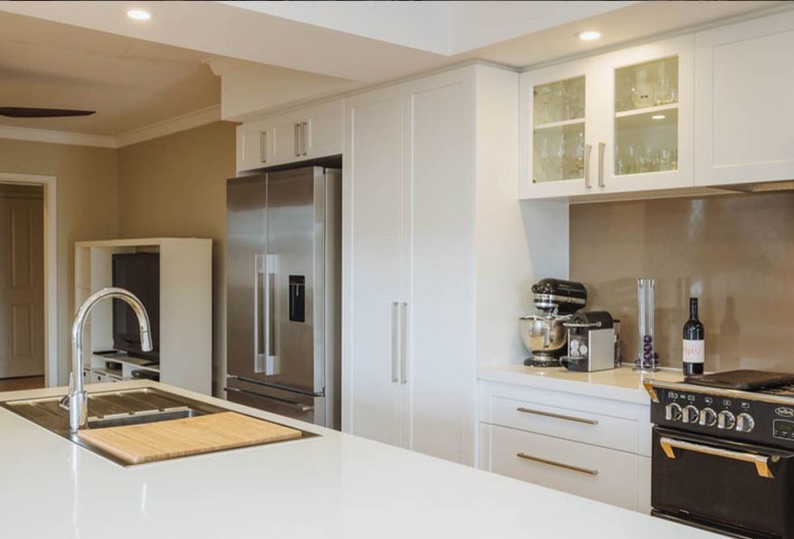 Example of a large minimalist galley light wood floor open concept kitchen design in Perth with an undermount sink, white cabinets, stainless steel appliances and an island