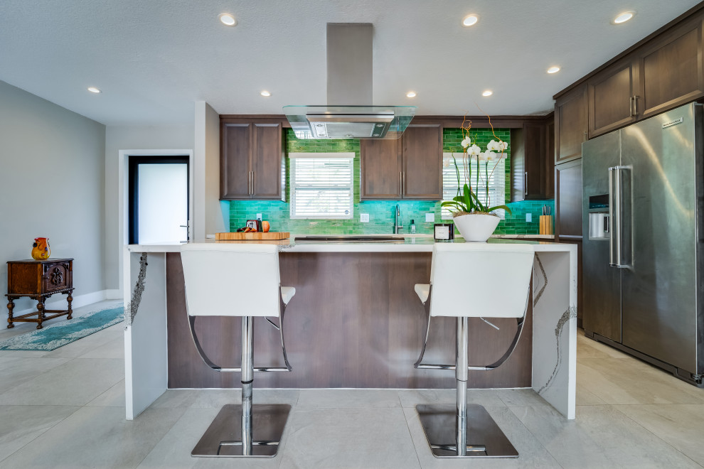 Medium sized modern galley kitchen/diner in Miami with a submerged sink, recessed-panel cabinets, medium wood cabinets, engineered stone countertops, green splashback, glass tiled splashback, stainless steel appliances, porcelain flooring, an island, grey floors and multicoloured worktops.