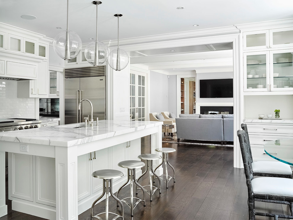 Inspiration for a mid-sized transitional l-shaped dark wood floor eat-in kitchen remodel in Other with an undermount sink, recessed-panel cabinets, white cabinets, marble countertops, yellow backsplash, subway tile backsplash, stainless steel appliances and an island