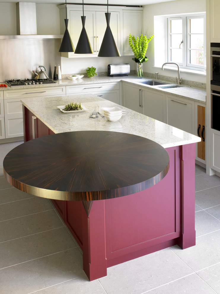 Kitchen - contemporary u-shaped kitchen idea in London with an undermount sink, shaker cabinets, granite countertops, metallic backsplash, metal backsplash, stainless steel appliances and white cabinets