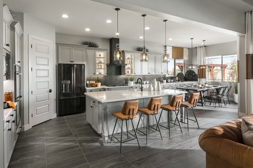Transitional gray floor eat-in kitchen photo in Phoenix with an undermount sink, shaker cabinets, gray cabinets, gray backsplash, subway tile backsplash, black appliances, an island and white countertops