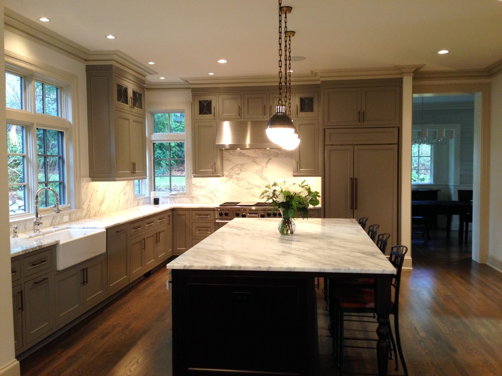 Example of a large classic dark wood floor kitchen design in Seattle with a farmhouse sink, gray cabinets, marble countertops, paneled appliances and an island