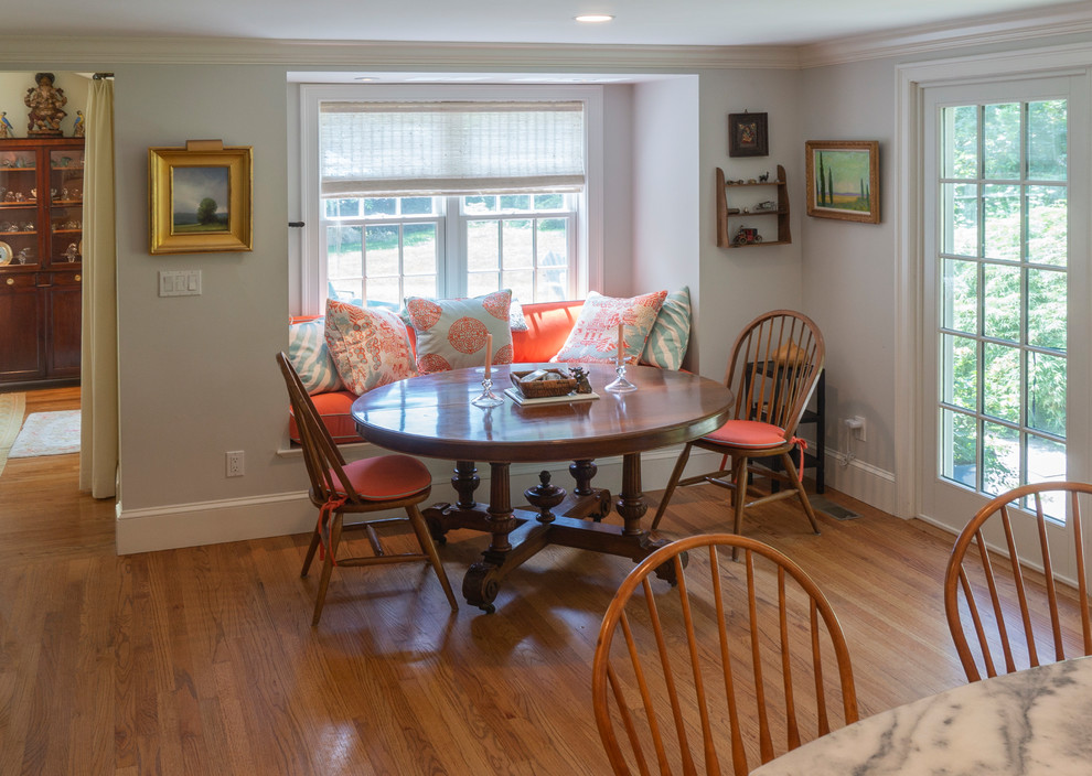 Photo of a large traditional kitchen/dining room with medium hardwood flooring and brown floors.