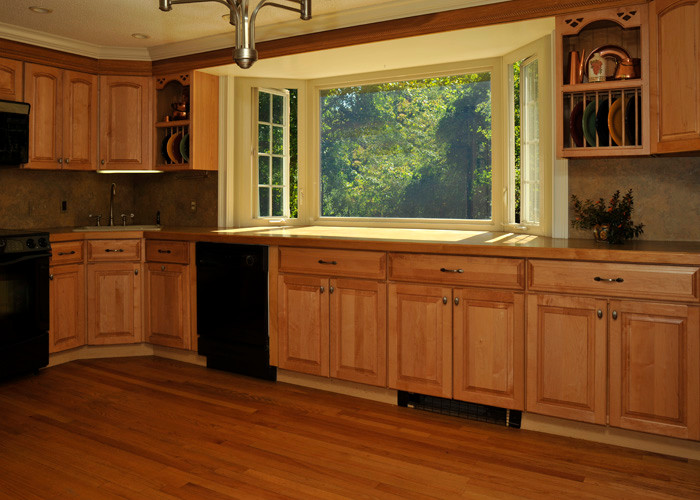 Ejemplo de cocina grande con armarios con paneles empotrados, puertas de armario de madera oscura, encimera de madera y suelo de madera en tonos medios