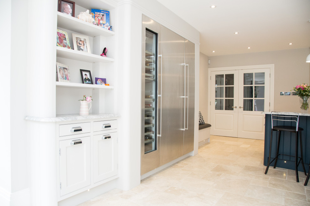 Inspiration for a medium sized modern u-shaped open plan kitchen in Berkshire with a submerged sink, shaker cabinets, white cabinets, marble worktops, grey splashback, marble splashback, stainless steel appliances, limestone flooring, an island, beige floors and white worktops.