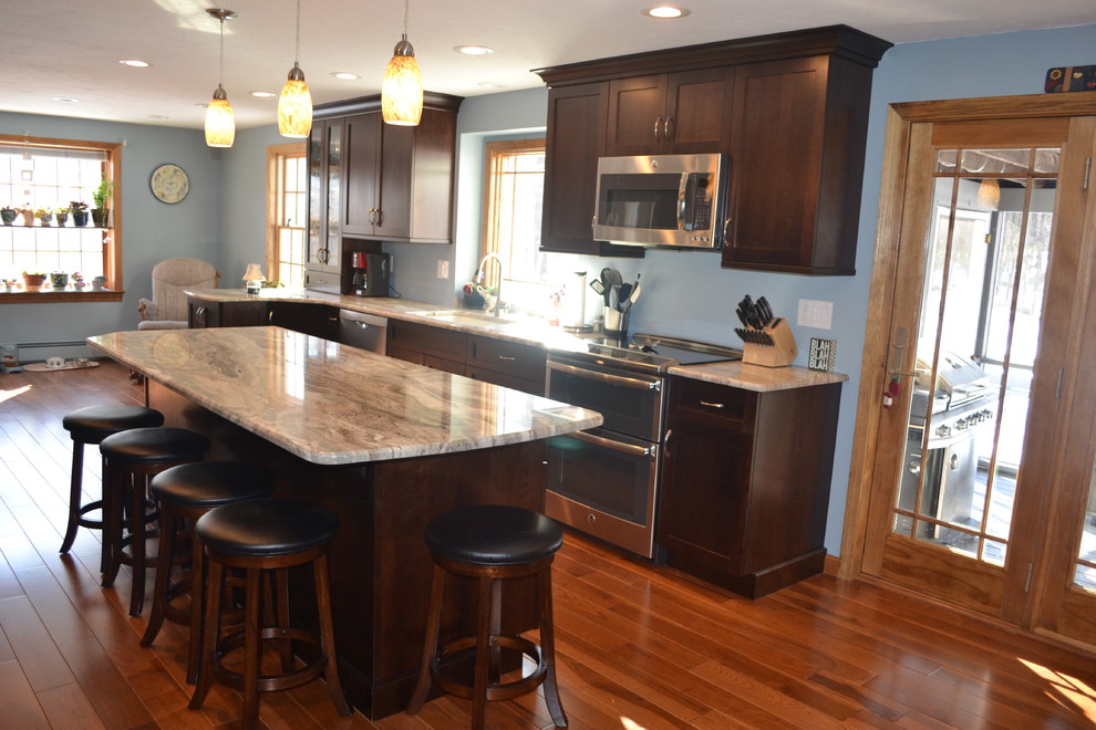 Photo of a medium sized classic single-wall kitchen/diner in Boston with a submerged sink, recessed-panel cabinets, dark wood cabinets, granite worktops, stainless steel appliances and medium hardwood flooring.