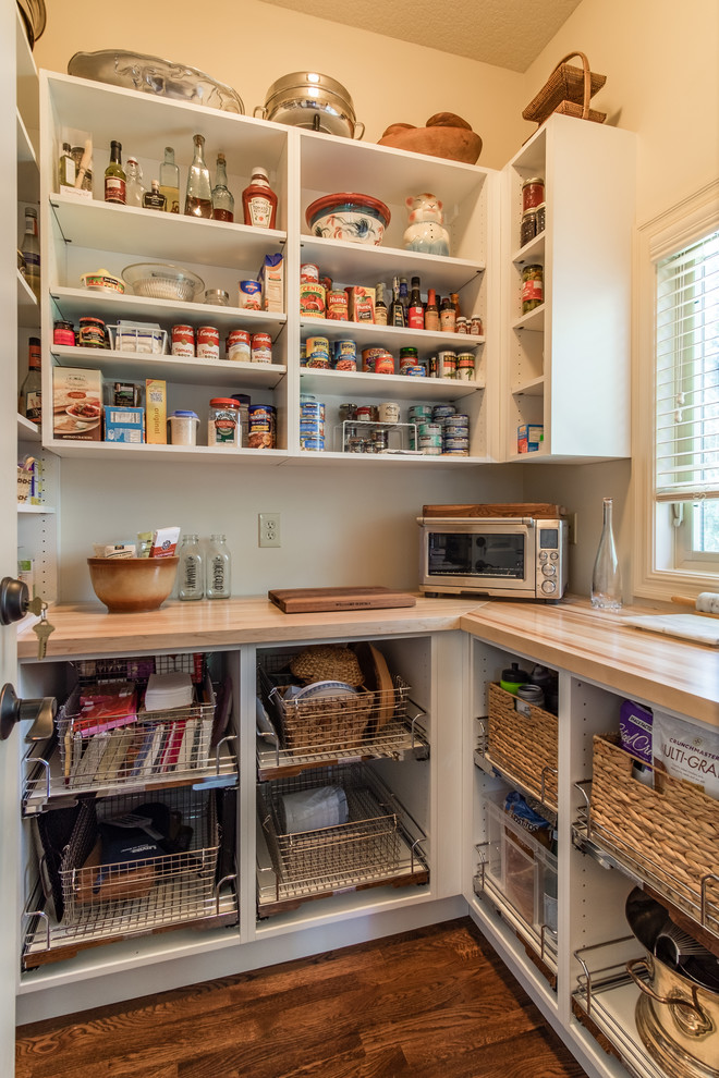 Inspiration for a large timeless u-shaped kitchen pantry remodel in Kansas City with open cabinets, white cabinets, wood countertops and white backsplash