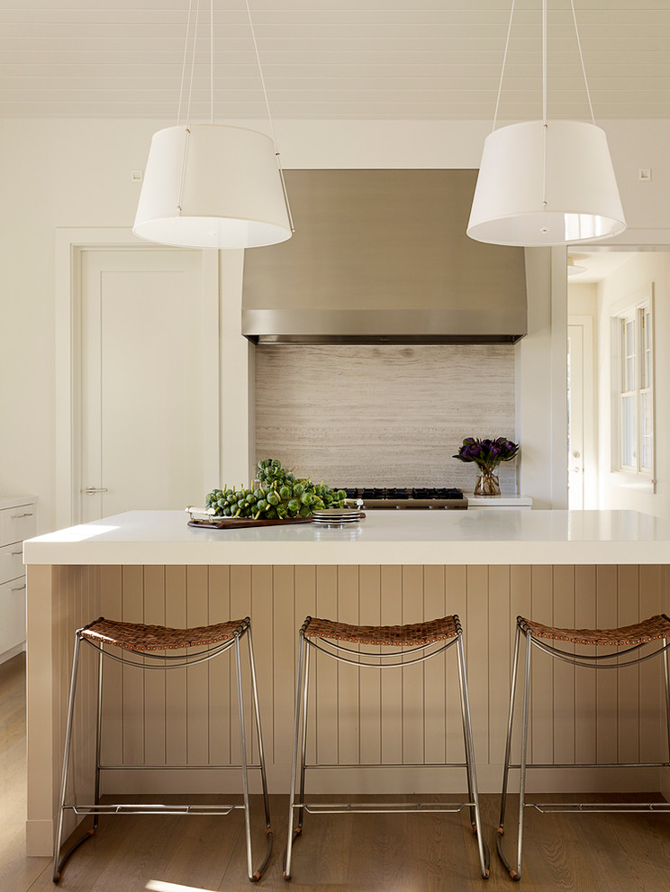 Inspiration for a transitional kitchen remodel in San Francisco with beige backsplash, an island and limestone backsplash