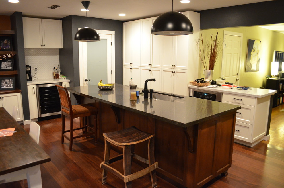 Eat-in kitchen - contemporary l-shaped dark wood floor eat-in kitchen idea in Sacramento with an undermount sink, recessed-panel cabinets, white cabinets, white backsplash, stainless steel appliances and an island